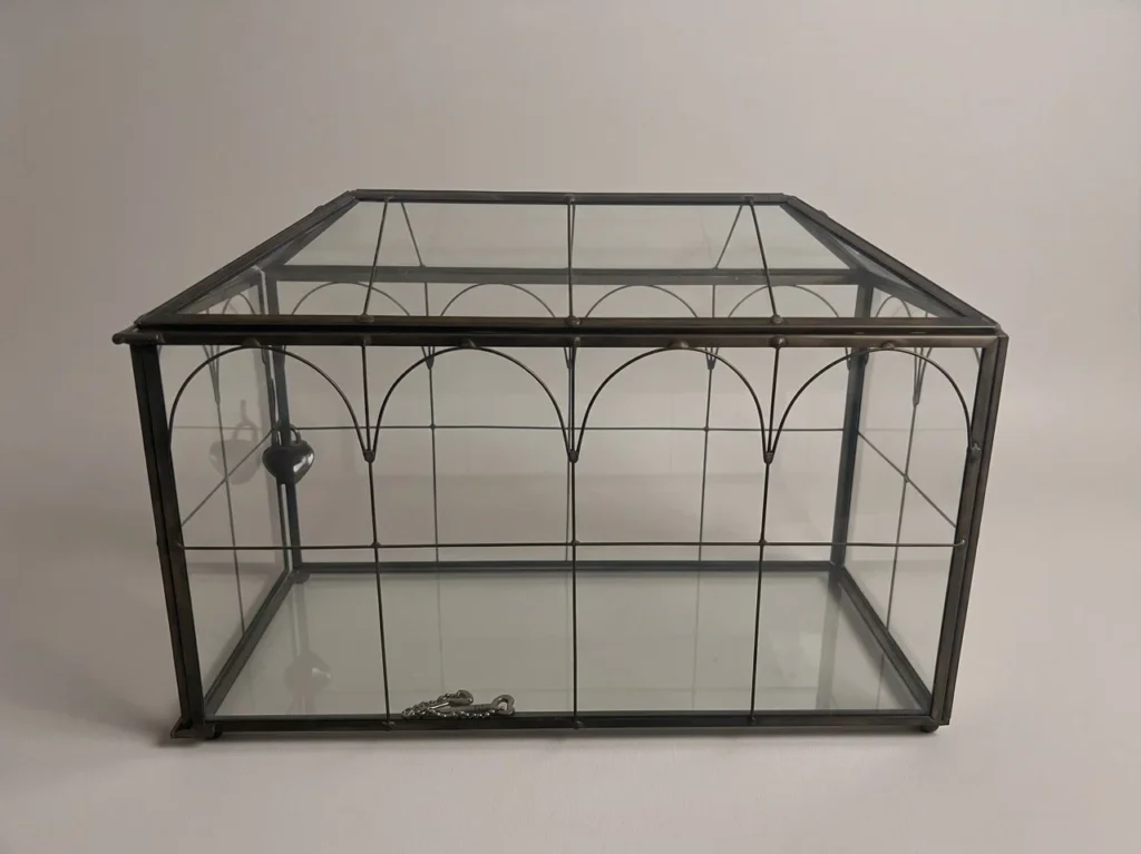 Black-framed glass card box with heart-shaped lock for wedding reception