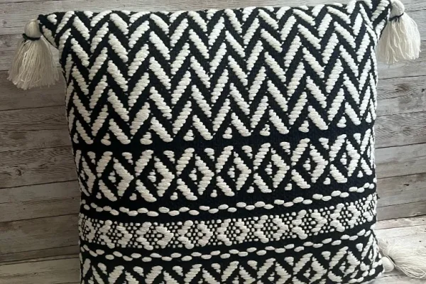 Black and ivory chevron rental pillow with corner tassels