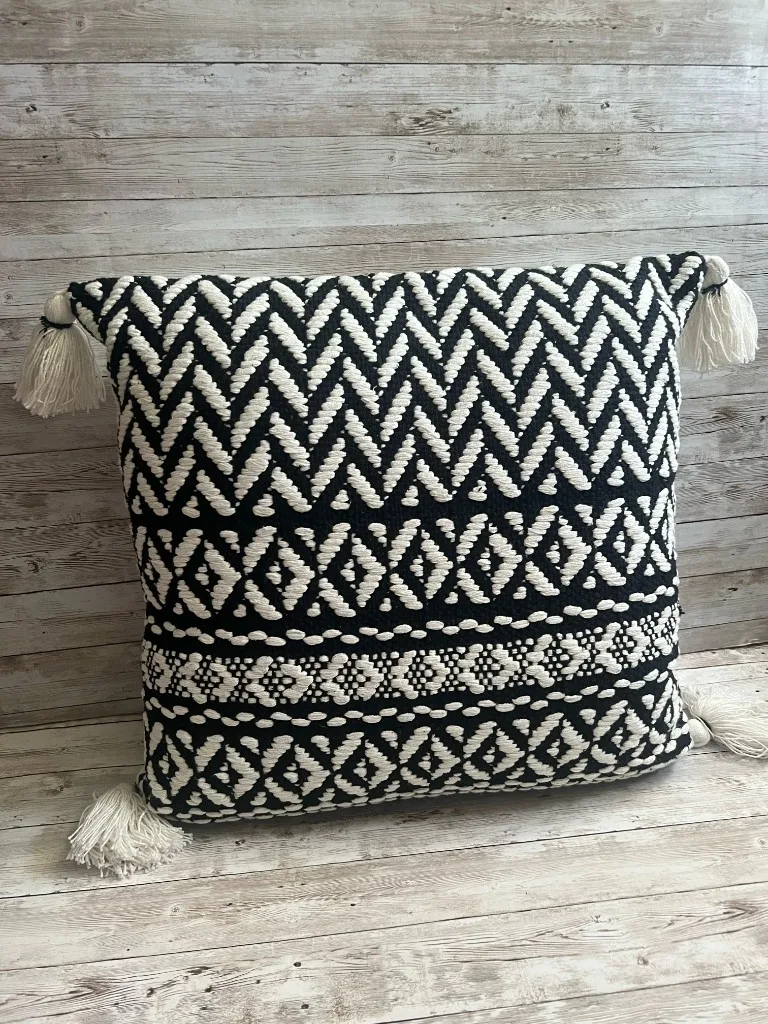 Black and ivory chevron rental pillow with corner tassels