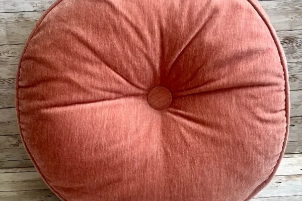 Coral round velvet rental pillow