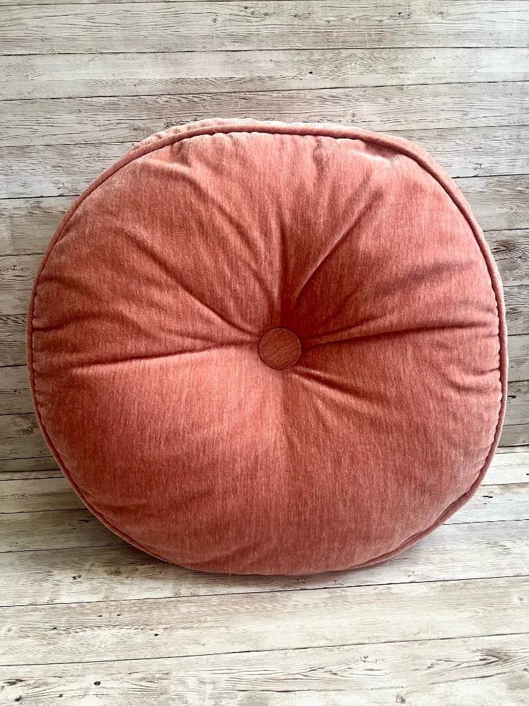 Coral round velvet rental pillow