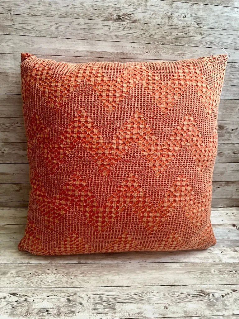 Coral woven diamond pattern rental pillow