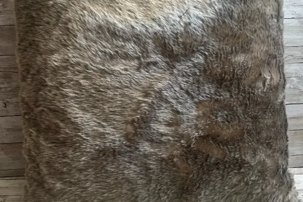 Neutral faux fur rental pillow