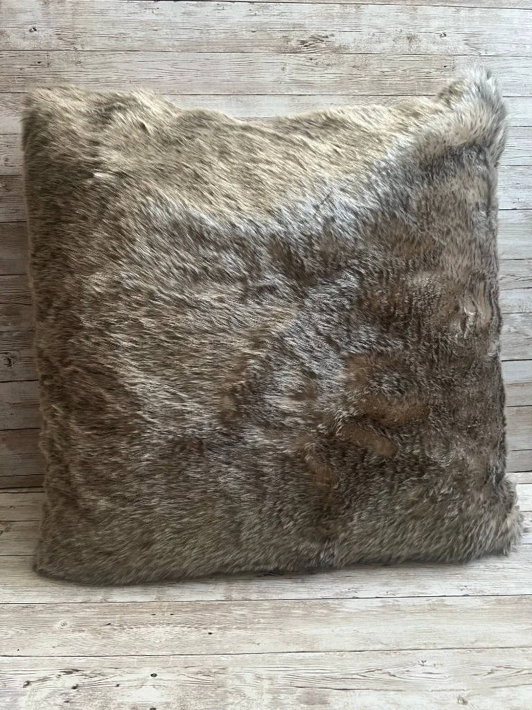 Neutral faux fur rental pillow