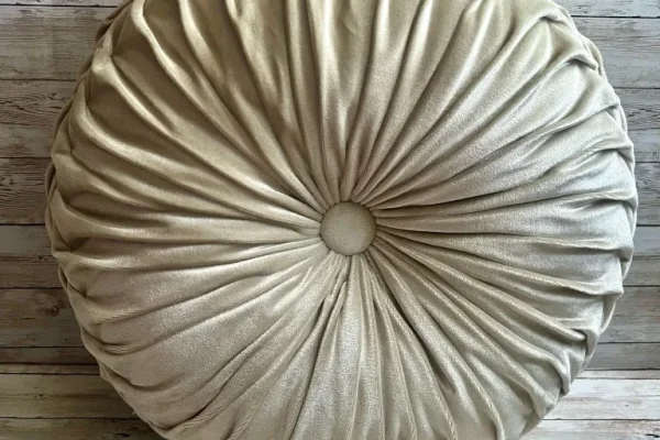 Ivory pleated round velvet rental pillow