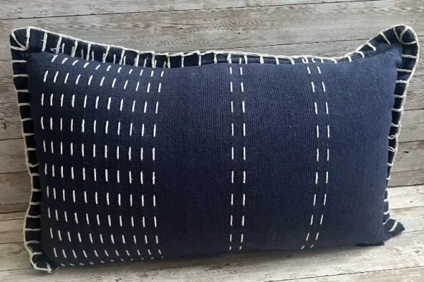 Navy lumbar rental pillow with cream stitching