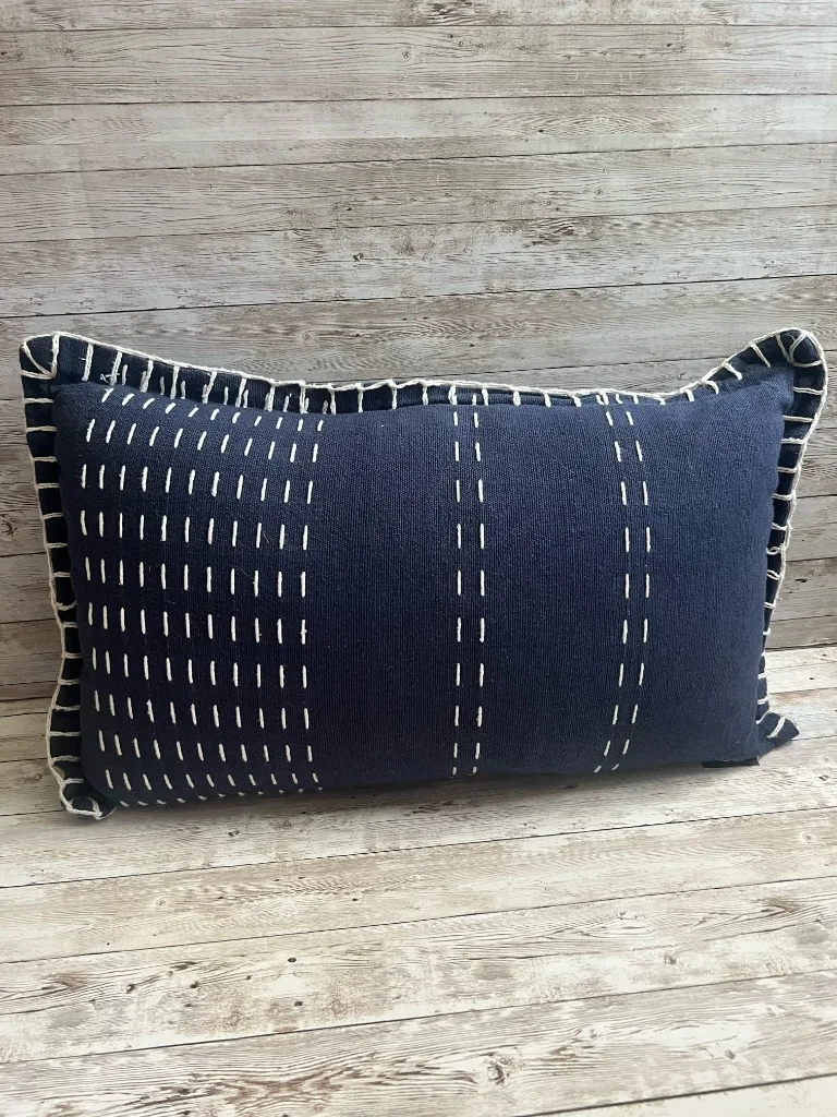 Navy lumbar rental pillow with cream stitching