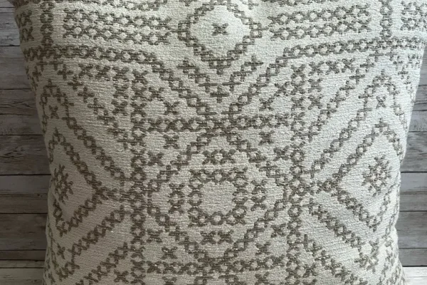 Neutral ivory and taupe medallion rental pillow