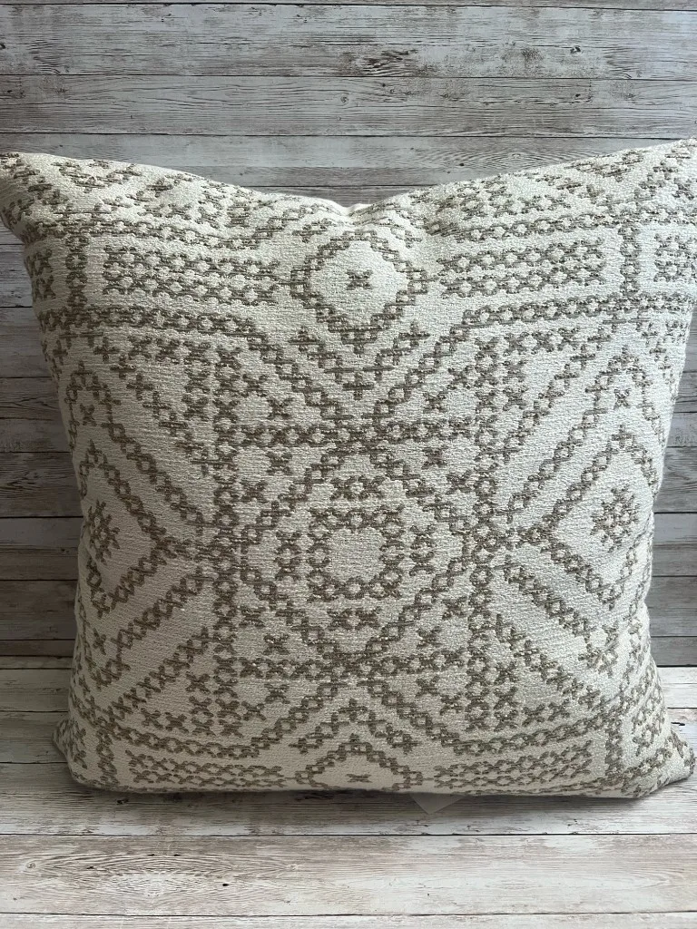 Neutral ivory and taupe medallion rental pillow