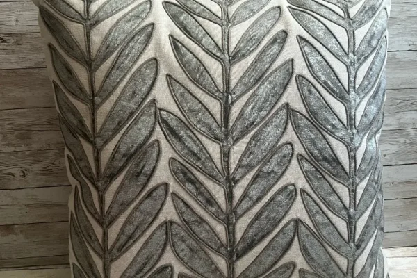Ivory rental pillow with silver leaf embroidery