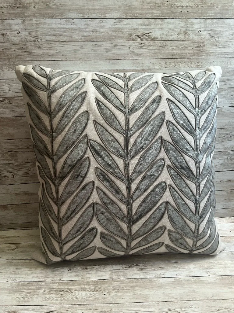 Ivory rental pillow with silver leaf embroidery