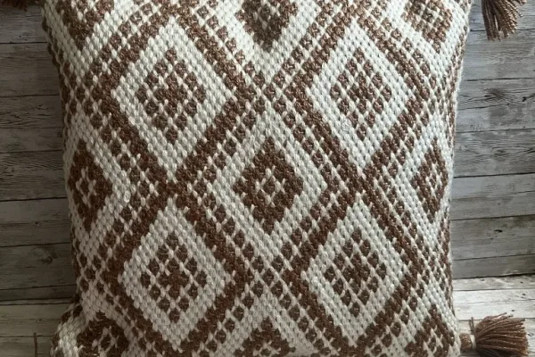 Taupe and ivory diamond pattern rental pillow with tassels