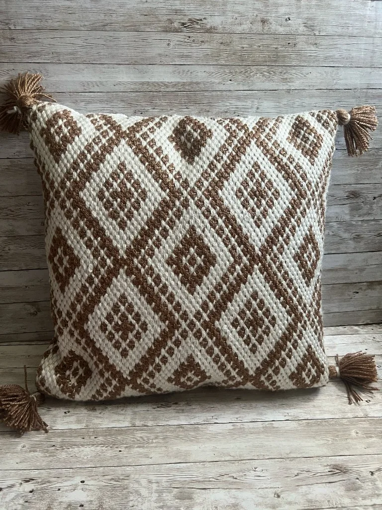 Taupe and ivory diamond pattern rental pillow with tassels